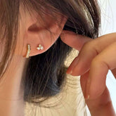 Hexagon pavé huggie paired with small diamond stud in ear
